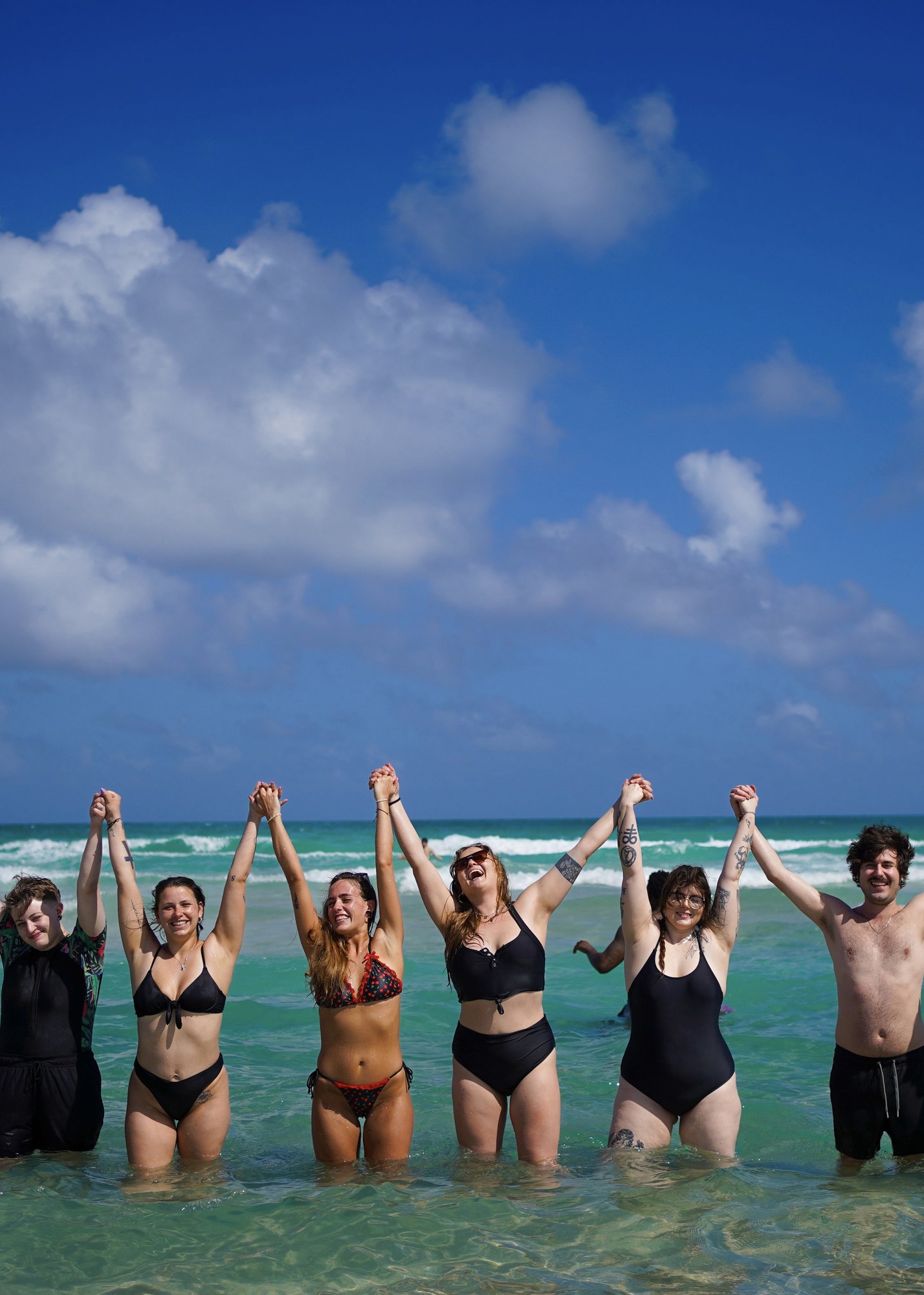 Friends celebrating together on the beach, Riviera Maya